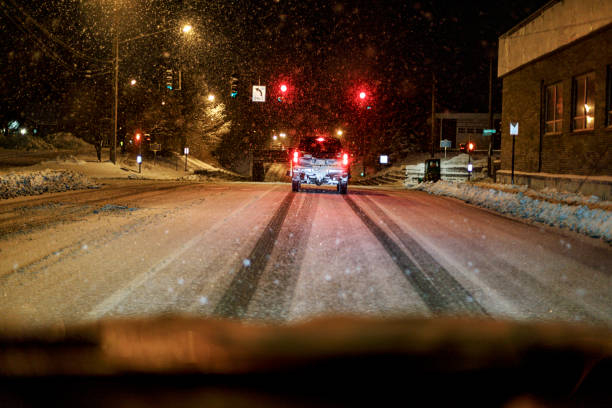 istock Pick-Up Truck Snowplow Waiting at Red Light at Night 1214624932