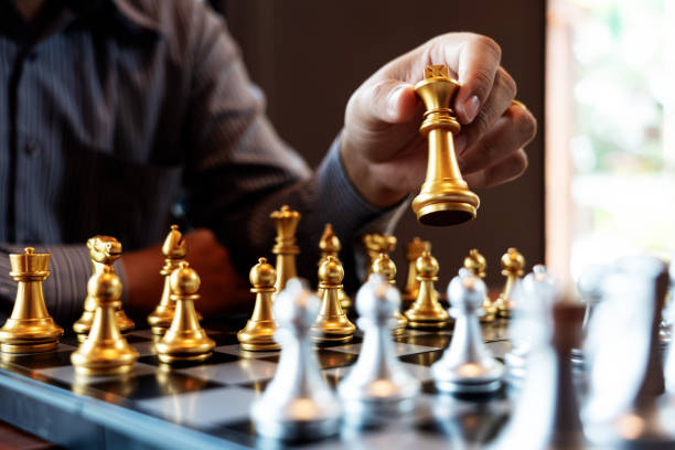 istock Business man take a king figure checkmate on the chess board game - strategy, management or leadership success concept 1214624974