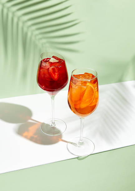 istock Red and orange summer cocktail on creative background 1214625274