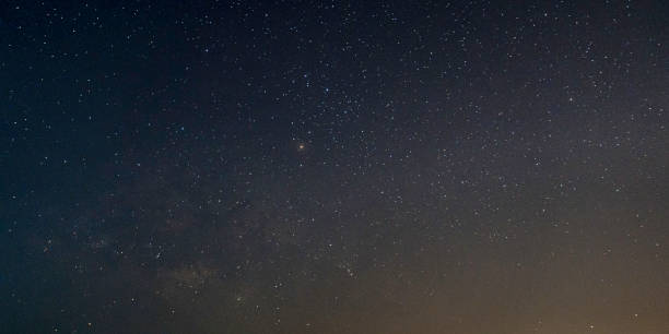 istock Milky way galaxy with stars on a night sky background 1214626338