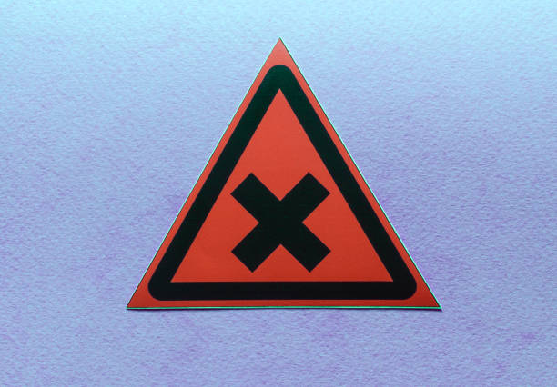 warning sign two intersecting lines in a red triangle on a blue background close up