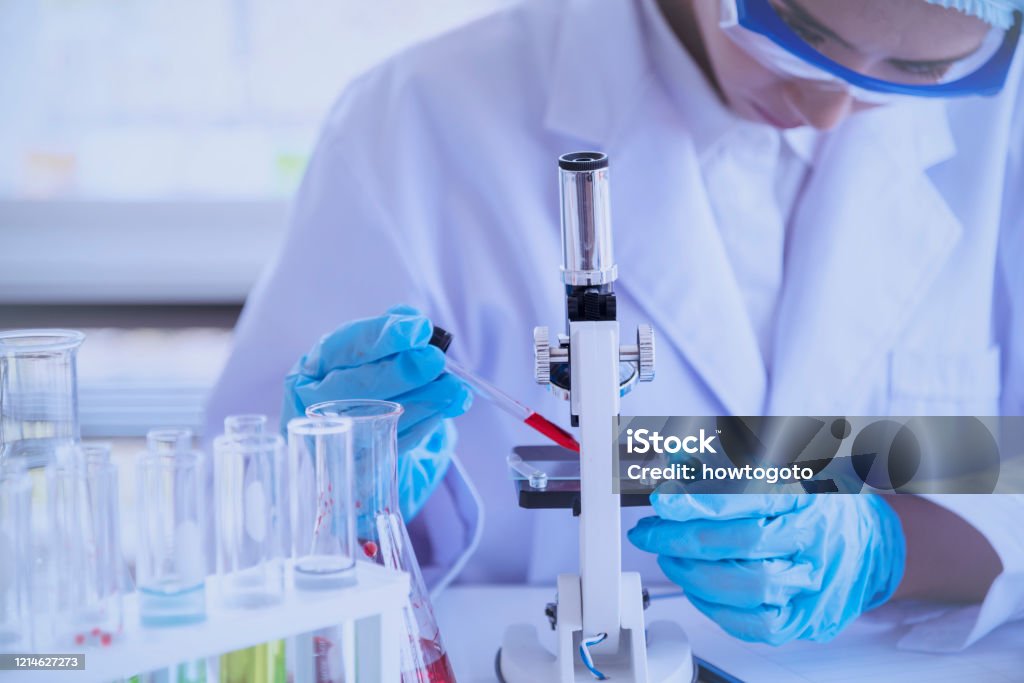 Scientific covid-19 virus antibody sample in laboratory research experiment biotech make cultivate vaccine against virus. Scientist look at microscope, science test tube analyse Chemistry laboratory Vaccination Stock Photo