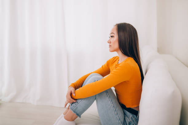 istock Girl sitting on the couch 1214627478