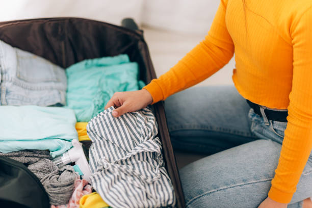 istock girl collects suitcase 1214627483