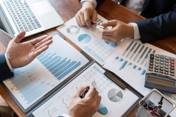 istock Business Corporate team brainstorming, Planning Strategy having a discussion Analysis investment researching with chart at office his desk documents and saving concept. 1214628499