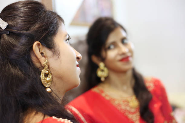 istock Women looking in mirror 1214629629