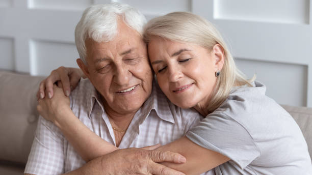 istock Close up older husband and wife hugging with closed eyes 1214631491