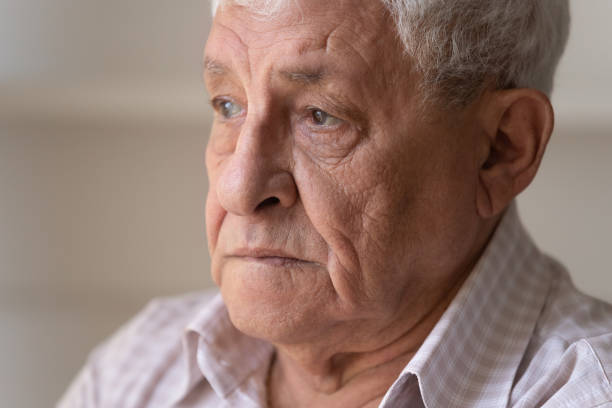 istock Close up unhappy lonely thoughtful older man looking in distance 1214631523