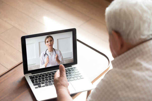 istock Close up older man talking with doctor online, video call 1214631533