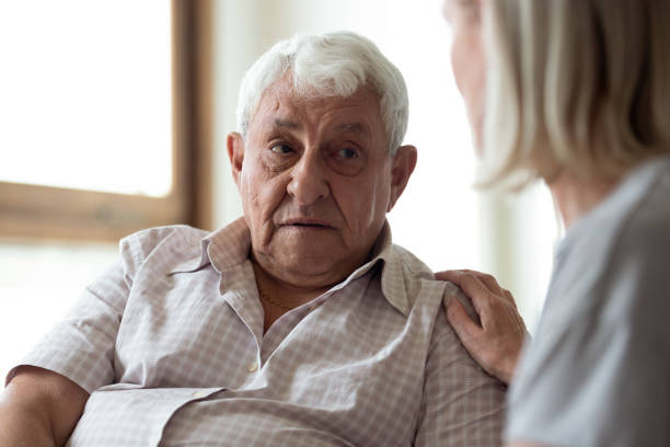 istock Middle-aged woman supporting upset older man, touching shoulder 1214631537