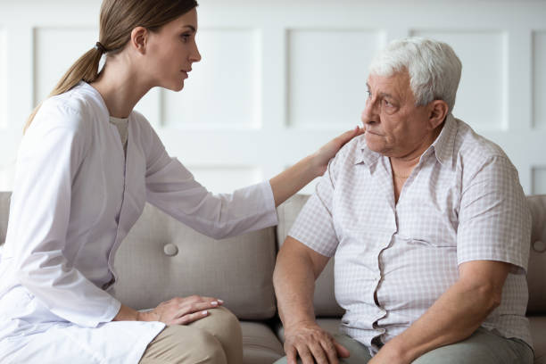 istock Caring doctor consulting, comforting older man patient, touching shoulder 1214631540