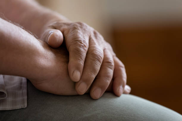 istock Close up folded wrinkled male hands, lonely mature man 1214631549