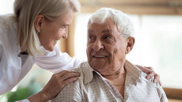 istock Close up middle-aged female doctor supporting older patient 1214631550