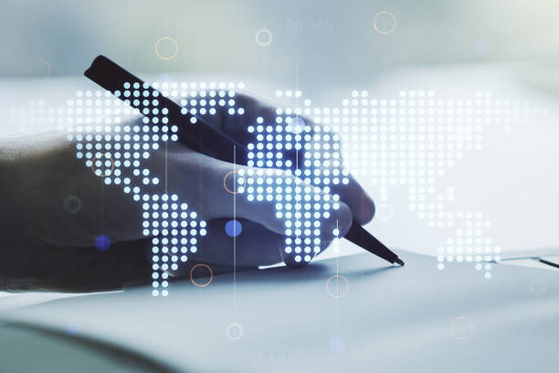 istock Abstract creative world map and man hand writing in notebook on background, international trading concept. Multiexposure 1214633591