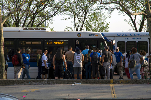 Bronx, New York/USA - May 3, 2018: People wait to board public bus number 13 near Yankee Stadium.