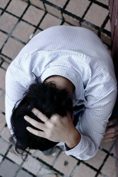 istock Top view of stressed depressed young Asian man feeling bad 1214634968