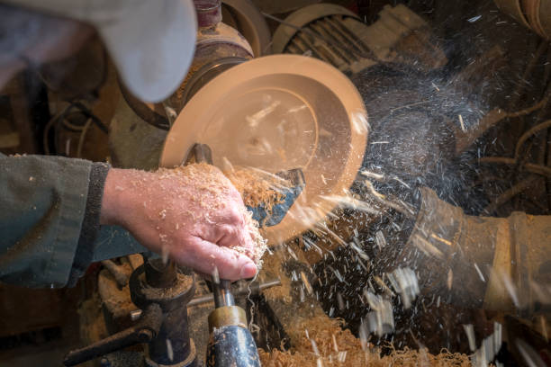 istock Making a wooden bowl on a lathe in an old small workshop 1214635698