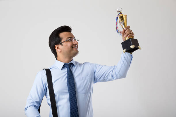 istock Successful businessman holding a trophy 1214635878