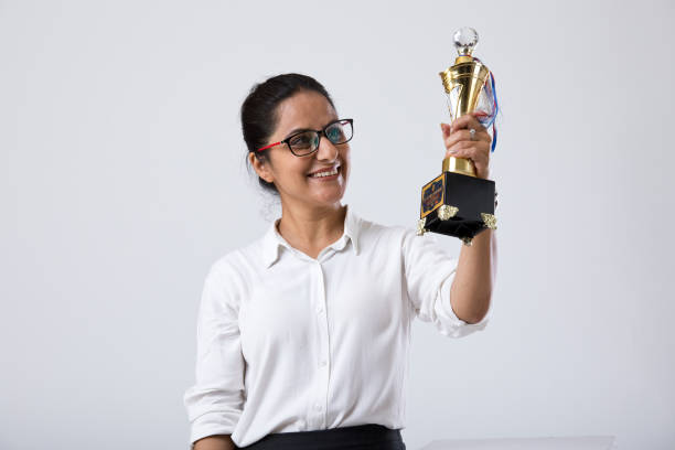 istock Successful businesswoman holding a trophy 1214636888