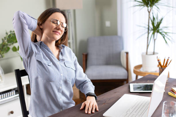 Freelancer young woman suffering with neck pain
