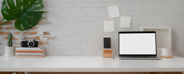 istock Cropped shot of comfortable workspace with mock-up laptop, smartphone, camera decorations and copy space 1214639954