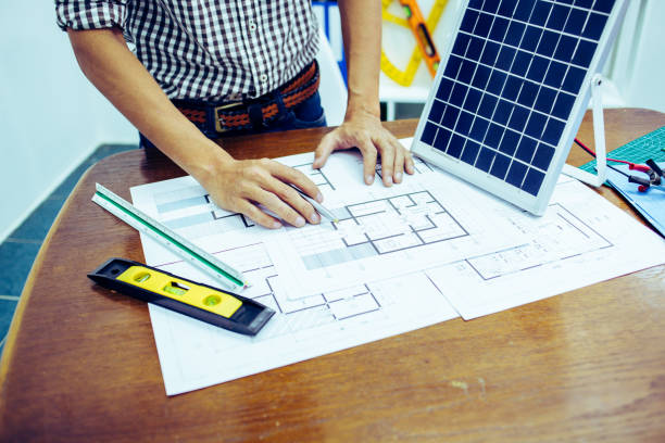 istock Architectural offiice site desk Solar cell background construction project ideas concept.Renewable energy 1214644890