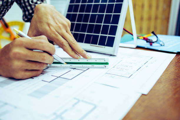 istock Architectural offiice site desk Solar cell background construction project ideas concept.Renewable energy 1214644909