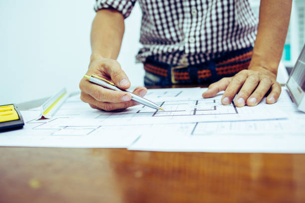 istock Architectural offiice site desk Solar cell background construction project ideas concept.Renewable energy 1214644969