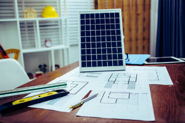 istock Architectural offiice site desk Solar cell background construction project ideas concept.Renewable energy 1214644970