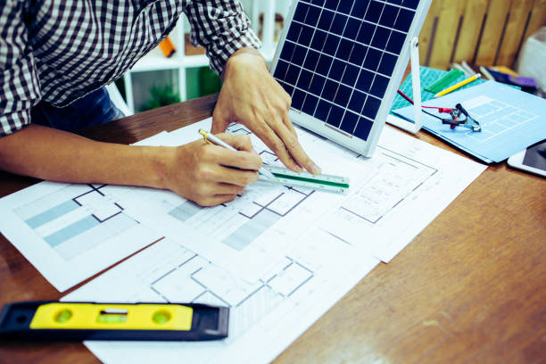 istock Architectural offiice site desk Solar cell background construction project ideas concept.Renewable energy 1214644978