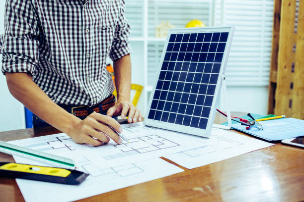 Architectural offiice site desk Solar cell background construction project ideas concept.Renewable energy
