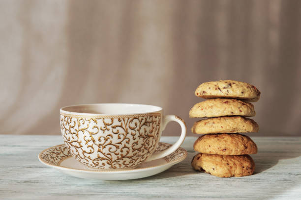 istock Freshly baked homemade biscuits  with cup of tea on plate. 1214645523
