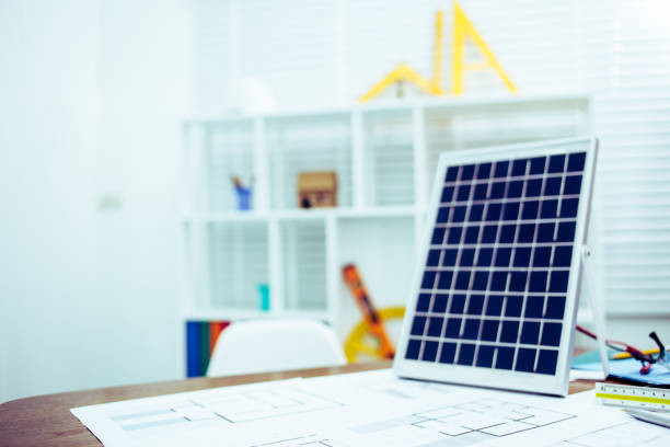 istock Architectural offiice site desk Solar cell background construction project ideas concept.Renewable energy 1214646399