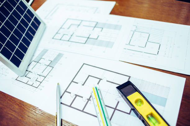 istock Architectural offiice site desk Solar cell background construction project ideas concept.Renewable energy 1214646405