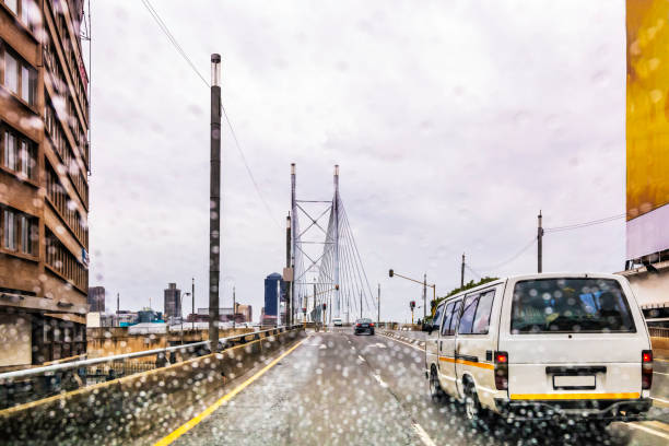 Taxi commuter travelling in the rain in Johannesburg city Taxi commuter travelling in the rain in Johannesburg city with Nelson Mandela bridge in the distance, rain drops on the lens, Johannesburg is also known as Jozi, Jo'burg or eGoli, is the largest city in South Africa. gauteng province photos stock pictures, royalty-free photos & images