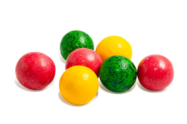 Sweet colorful caramel round candies red, green and yellow on a white background. Sweet colorful caramel round candies red, green and yellow on a white background. Delicious sugar lollipop balls with fruit filling. gumball machine stock pictures, royalty-free photos & images