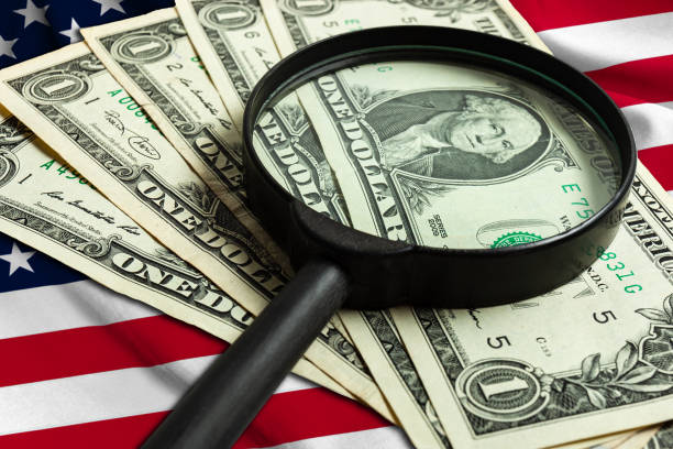 istock Increased one US dollar banknote through a magnifying glass. 1214648663