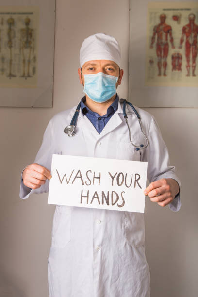 istock Doctor holding stop sign  Stop COVID-19 conceptual image. 1214650036