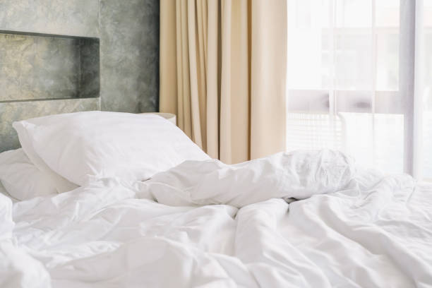 istock wrinkle white messy blanket on bed in bedroom in morning 1214650822