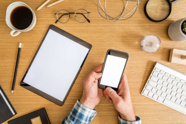 istock Stylish home office composition of businessman who are using mock up tablet screen, office supplies, cacti, phone, notes, plants and personal accessories in flat lay business concept. 1214652262
