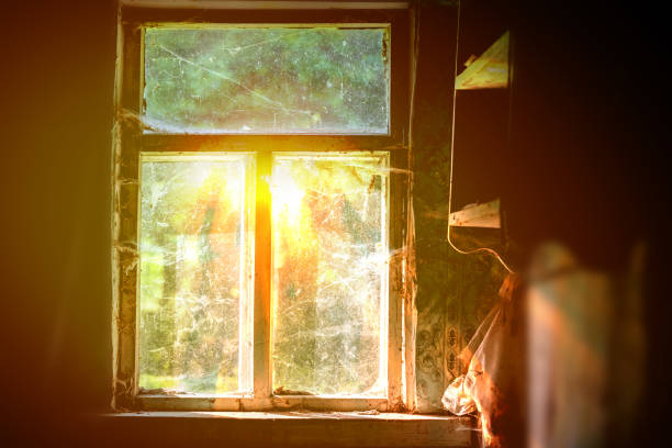 a window fogged up from below, glowing in the night with curtains of tulle and curtains