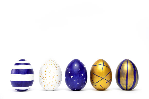 istock Five easter eggs trendy colored classic blue, white and golden decorated on white table. Happy Easter card with copy space for text. Minimal style 1214655169