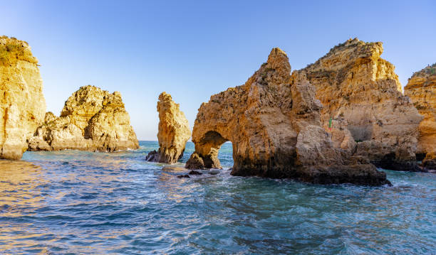 Beautiful beach on Algarve coast, Portugal This pics shows beautiful ponta da piedade rocks at algarve coastline in portugal. Atlantic ocean and beautiful cliffs are seen in the pic and the pic is taken in January 2020. beautiful beach in carvoeiro algarve portugal stock pictures, royalty-free photos & images
