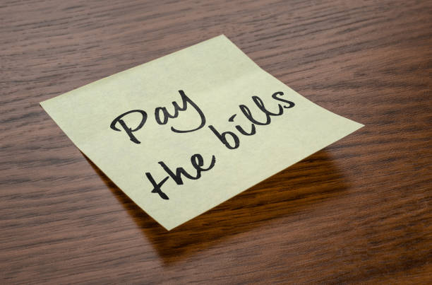 istock Sticky note with the text Pay the bills 1214658359