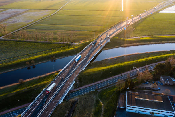 A viaduct bridge crossover a canal of highway A59 during sunrise near Waalwijk, Noord Brabant, Netherlands A viaduct bridge crossover a canal of highway A59 during sunrise near Waalwijk, Noord Brabant, Netherlands berkel stock pictures, royalty-free photos & images