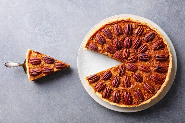 istock Pecan nut pie, on a plate. Grey background. Close up. Top view. 1214661072