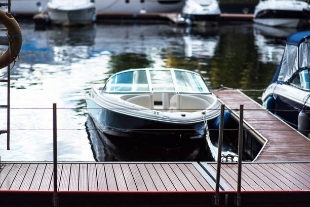 istock Small motor boat at anchor by rope in Replot pier 1214661174