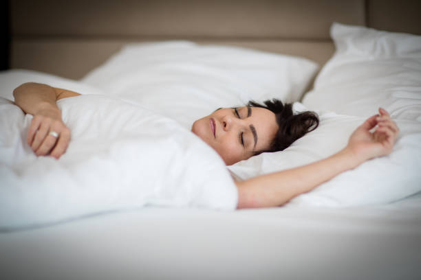 istock Beautiful young woman sleeping in bed 1214662123