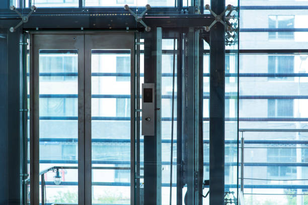 istock Glass elevator ,Businessman taking modern glass elevator to the upper floors, high building ,office and shopping mall and hotel, transportation 1214663394