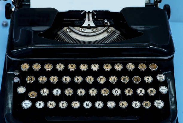 istock Old vintage typewriter with a blank sheet of paper inserted 1214669624